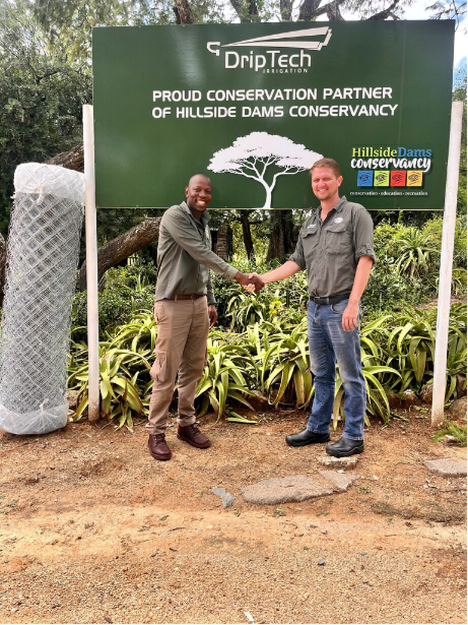 Hillside Dams Conservancy and DripTech representatives beside donated fencing materials